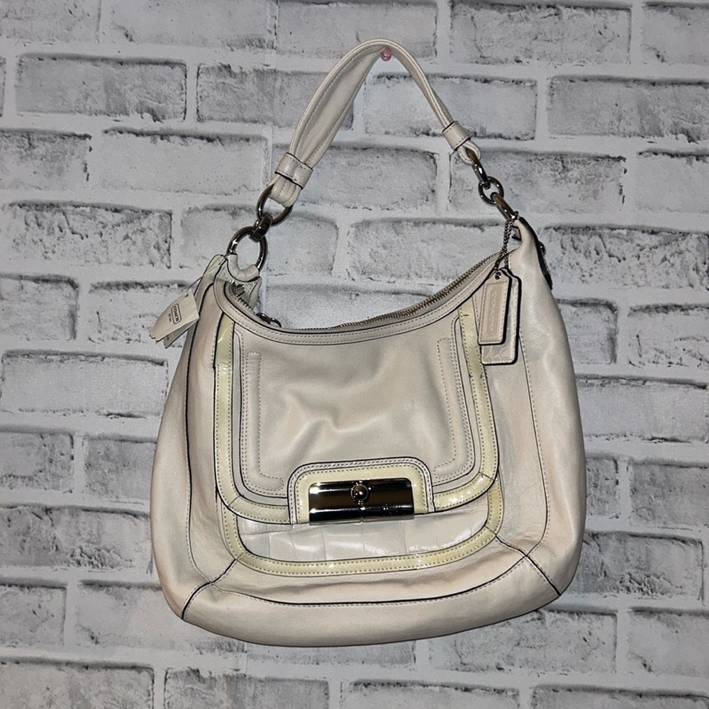 White coach bag with tags still on.